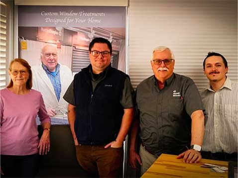 Company staff standing together and smiling inside the store
